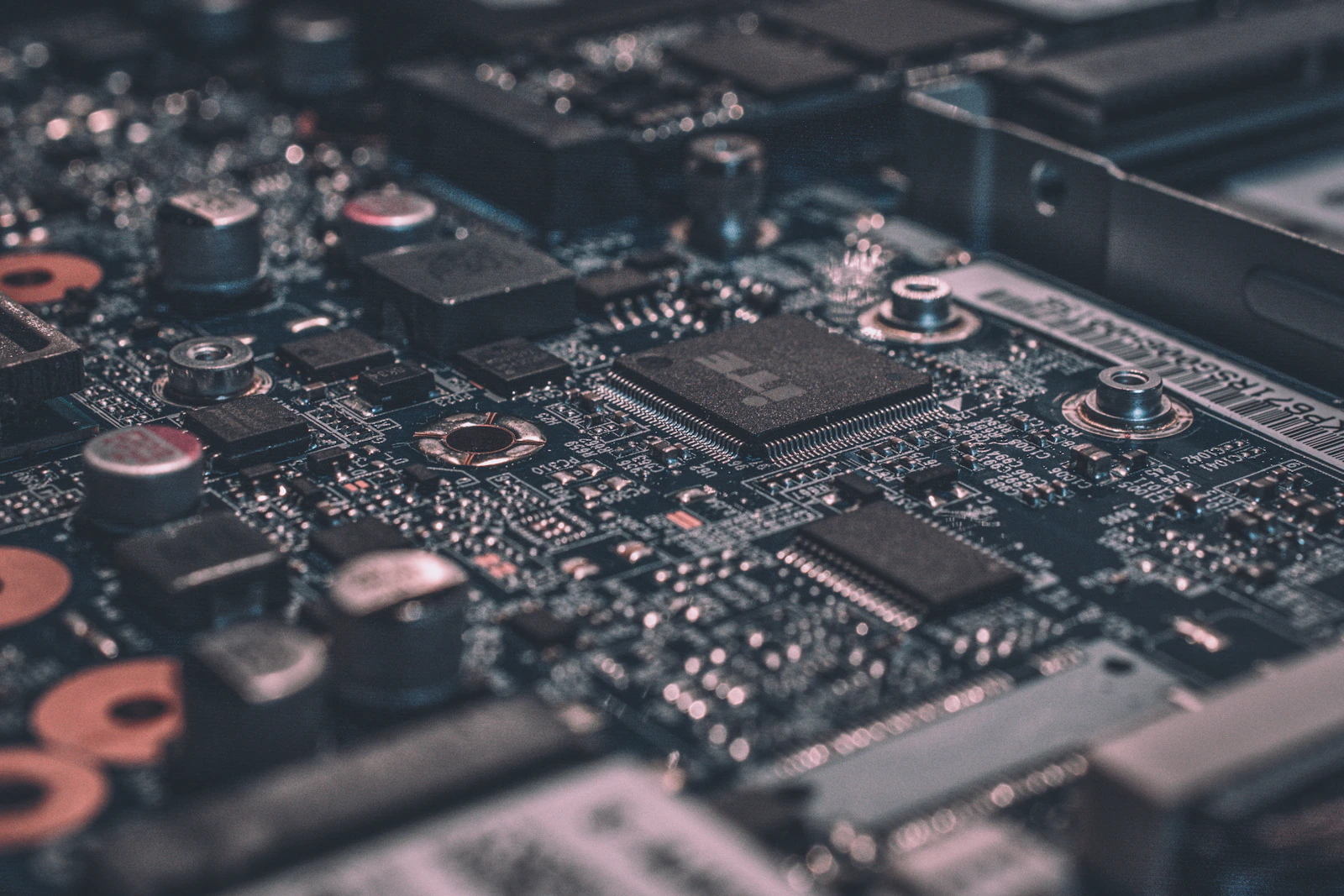 Detalhe macro de uma placa de circuito com trilhas azuis iluminadas